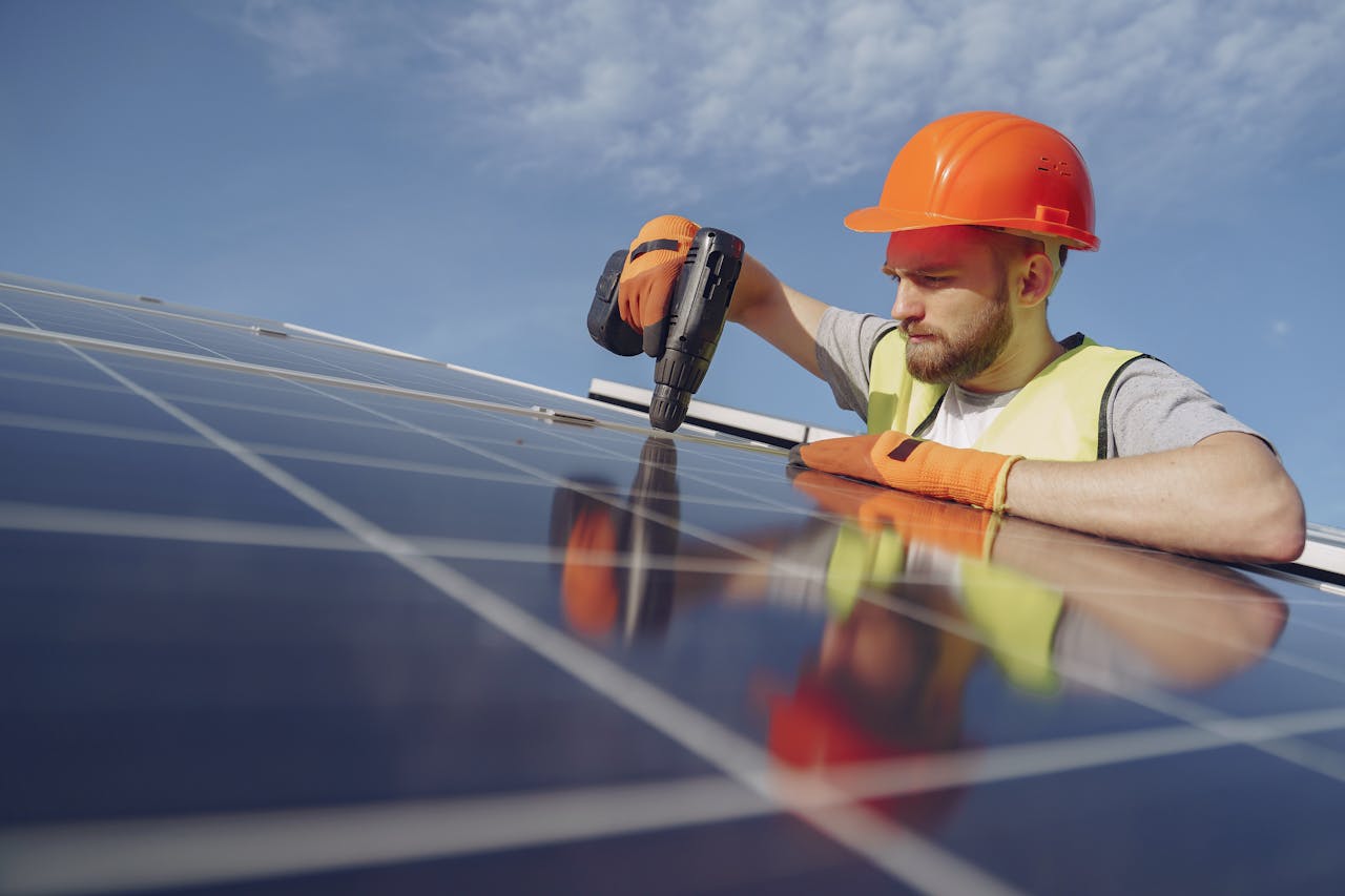 Electrician installing solar panels on a roof